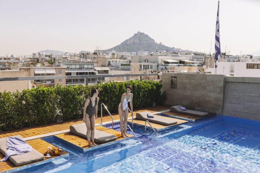 _electra_metropolis_athens_pool_lifestyle_sunbeds_jumping_into_pool_resized