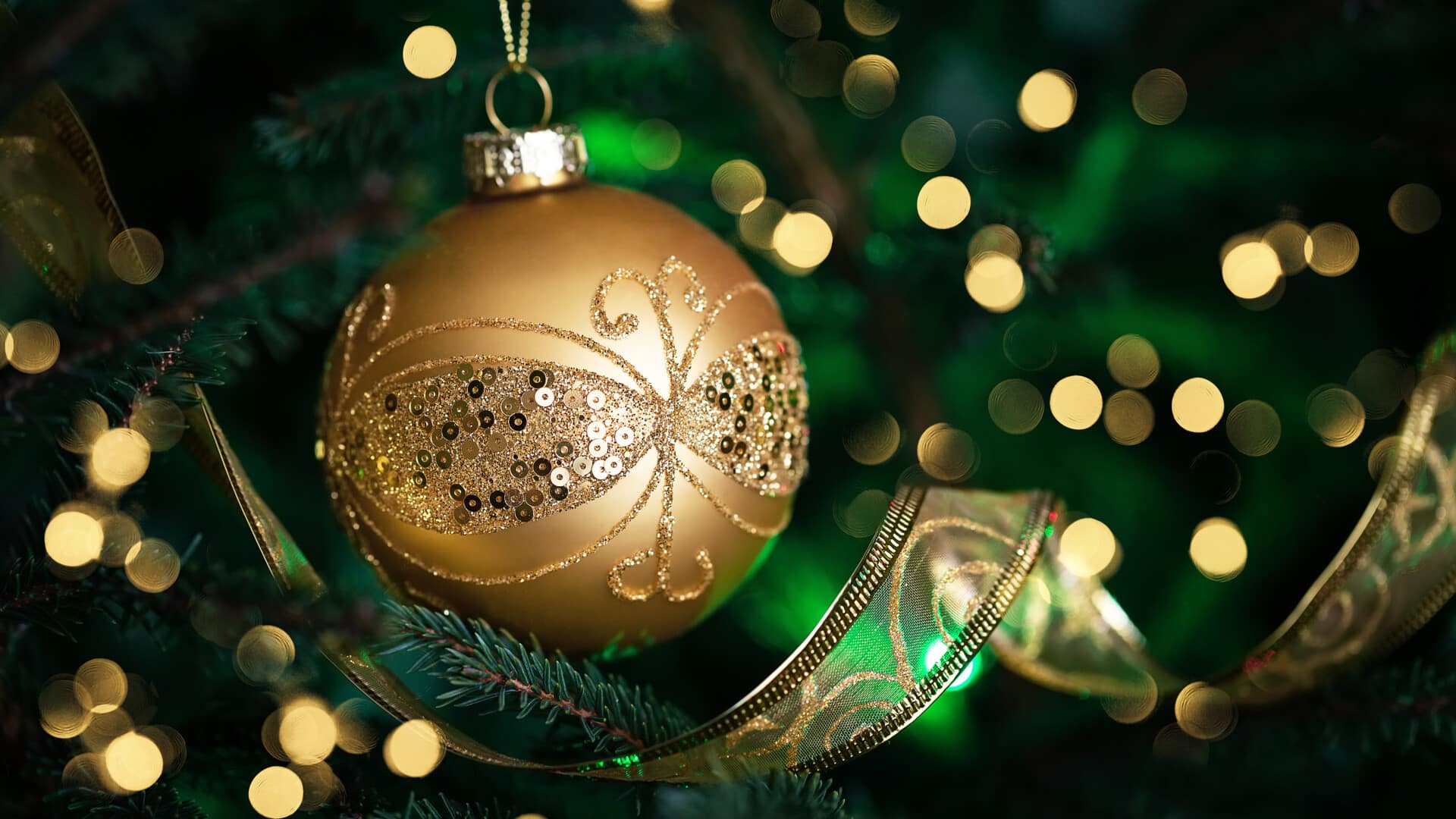 Close Up Of Golden Ball On Christmas Tree. Christmas Fir Tree Wi