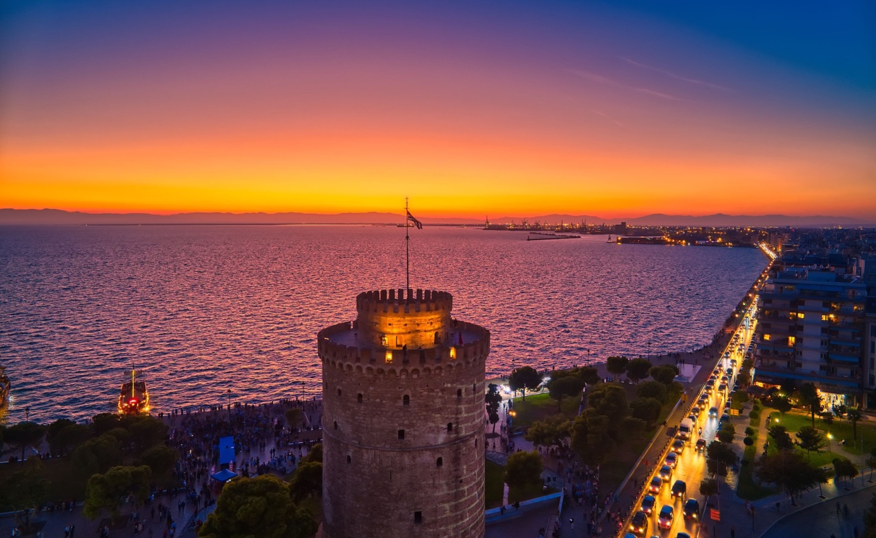 The sun setting over the White Tower and Thermaic Gulf commences the vibrant Thessaloniki nightlife scene.