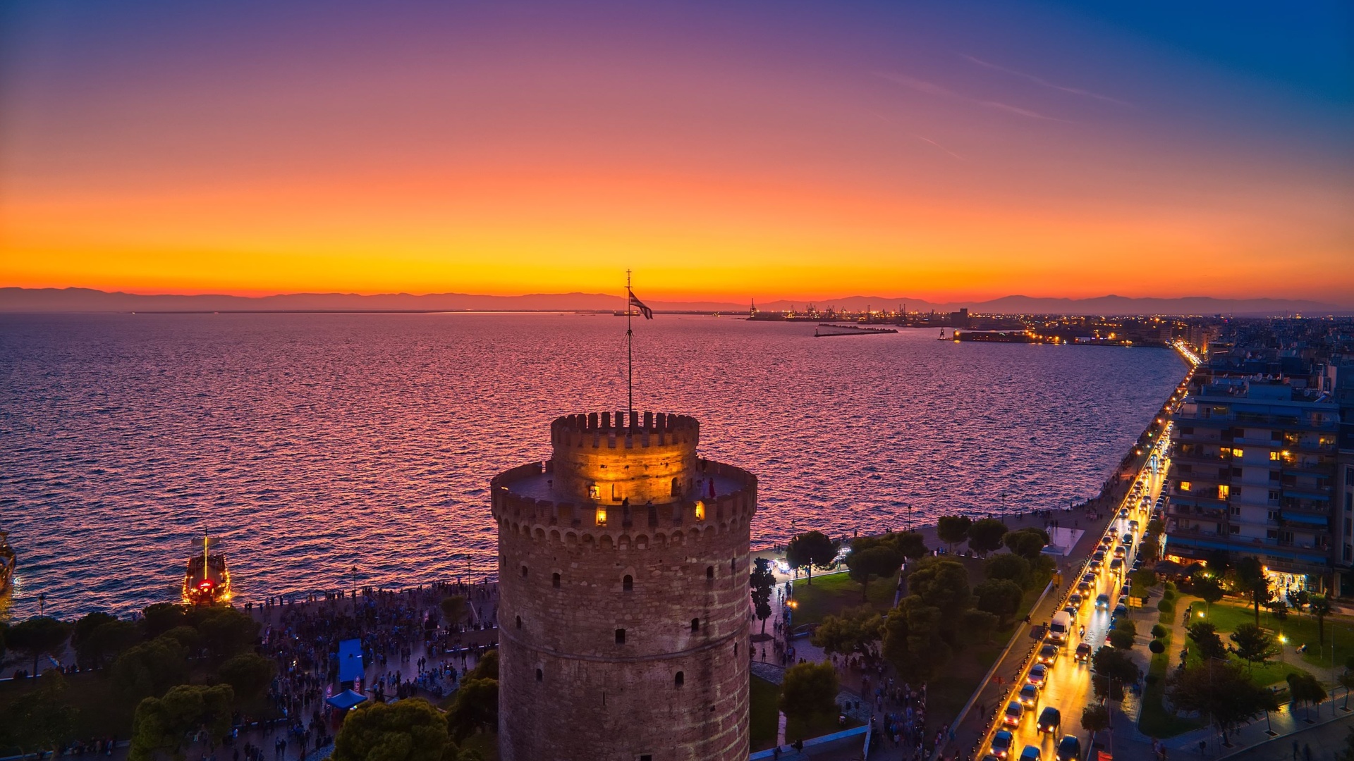 The sun setting over the White Tower and Thermaic Gulf commences the vibrant Thessaloniki nightlife scene.