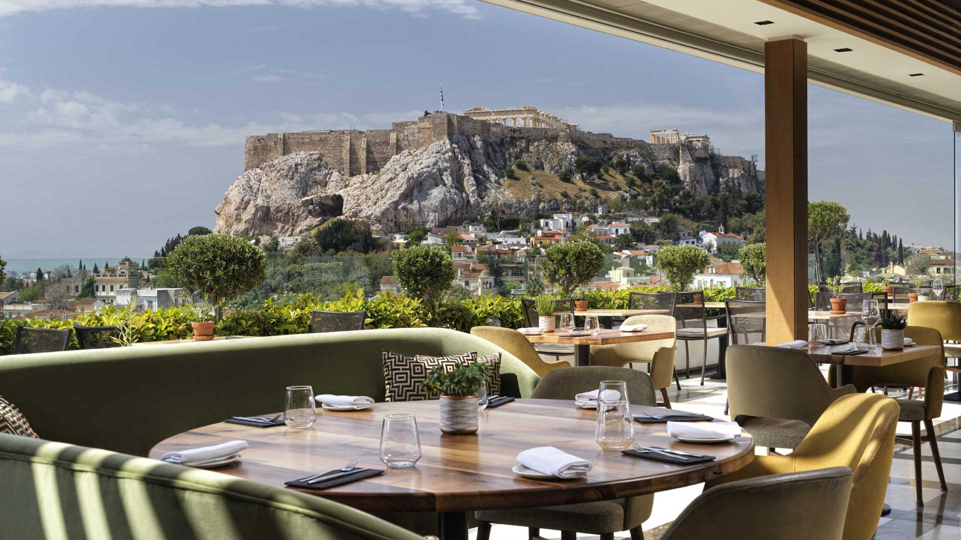 The setting for enjoying gourmet Athens cuisine with Acropolis views at Electra Palace Athens hotel’s rooftop.
