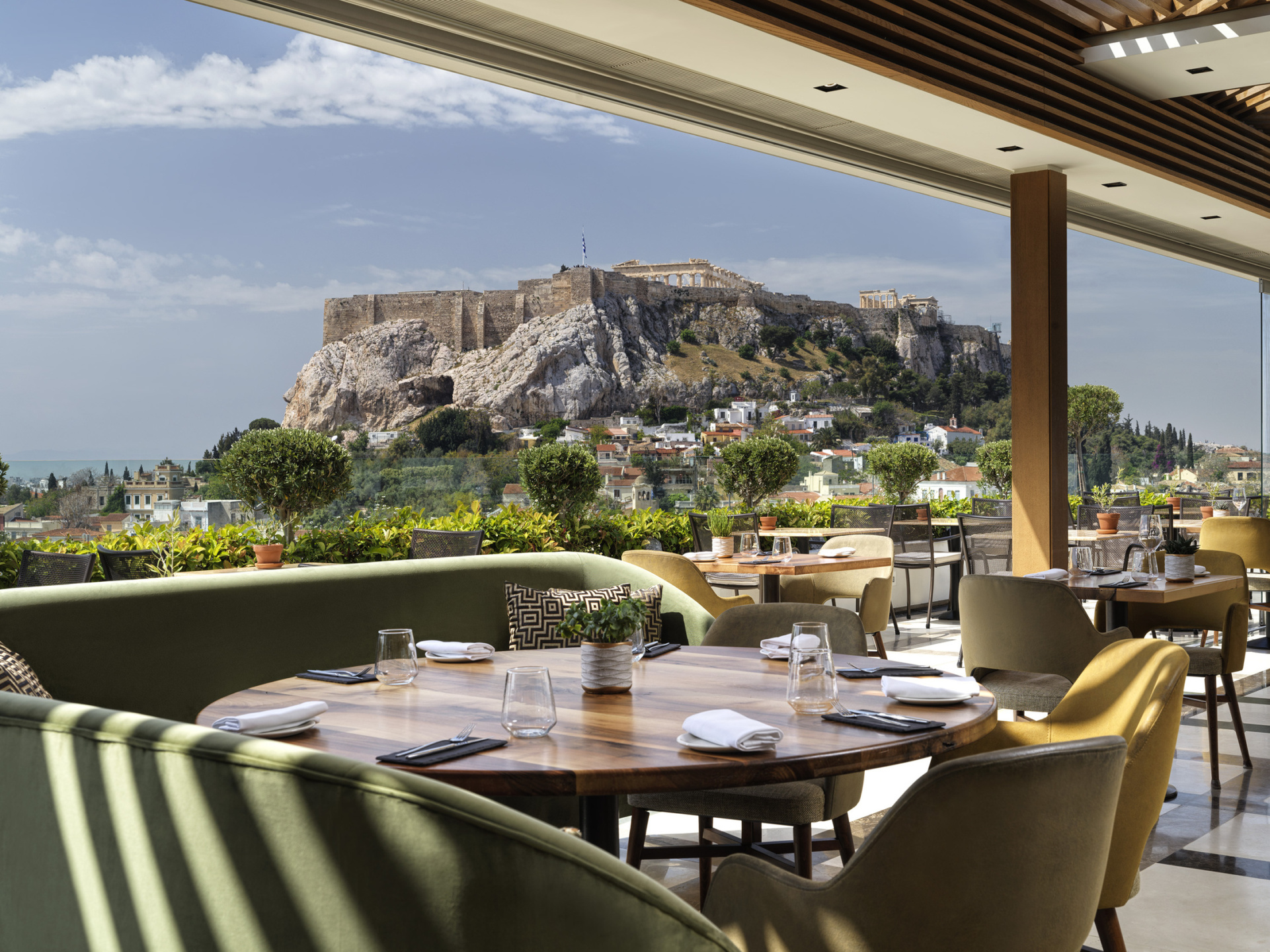 The setting for enjoying gourmet Athens cuisine with Acropolis views at Electra Palace Athens hotel’s rooftop.