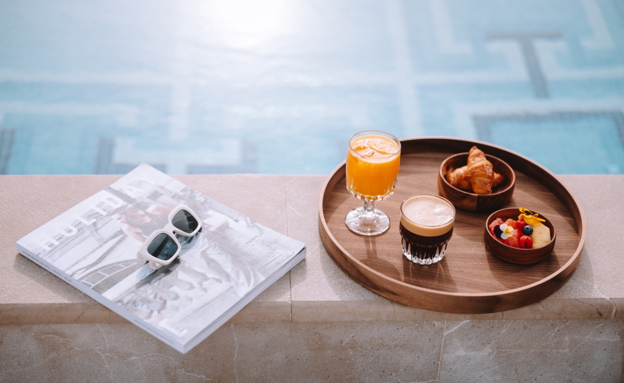 Breakfast tray by the pool at Electra Hotels, a top choice for those in search of wellness hotels in Athens city