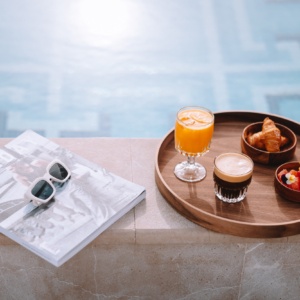Breakfast tray by the pool at Electra Hotels, a top choice for those in search of wellness hotels in Athens city